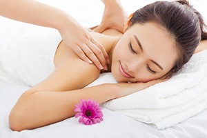 young woman in spa salon getting massage